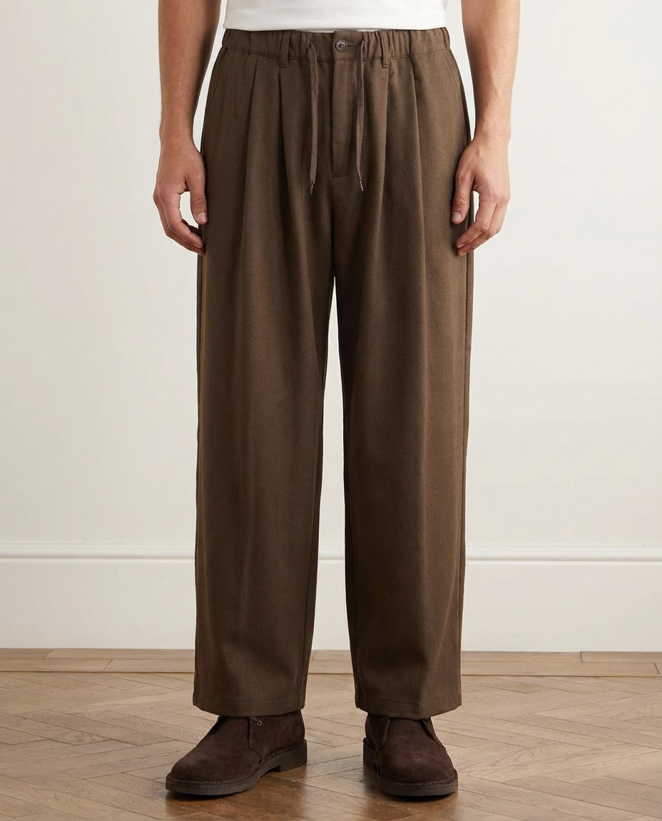 Person wearing brown pants on a plain background